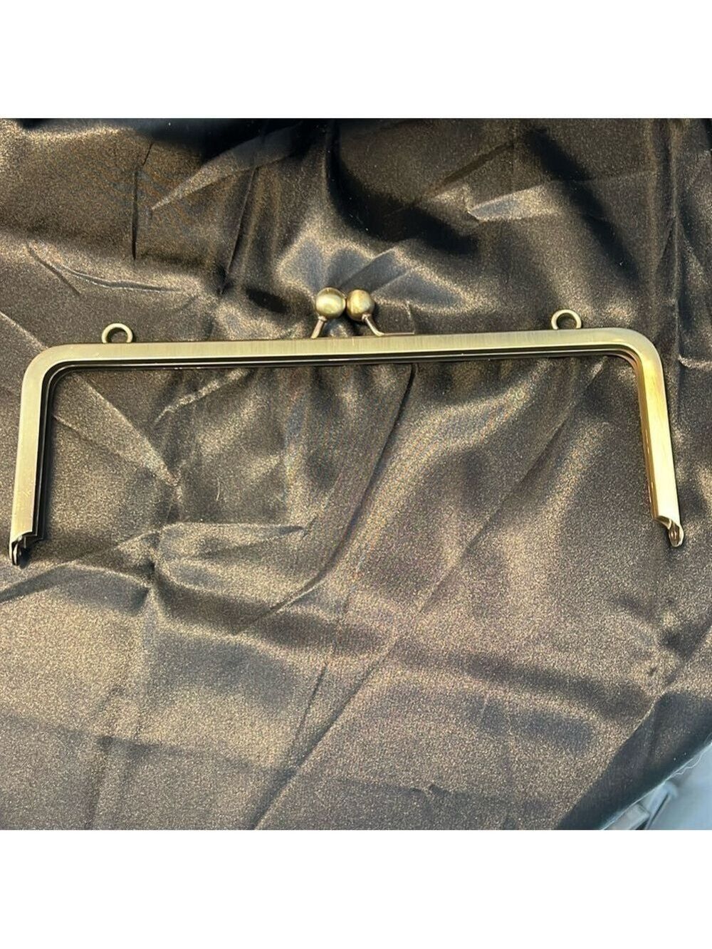Purse top frame with kiss closure. 10” x 3”. Bronze. 9 frames & 4 -36” chains.
